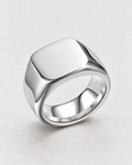 PARLX Axis Band rounded-square signet ring in polished steel on light concrete