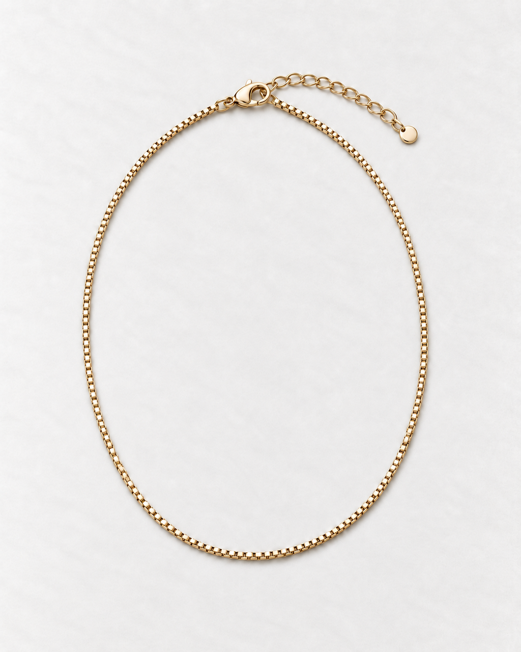 PARLX Box Chain Necklace in champagne gold tone on light concrete — existing render with standardized catalog styling