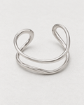 PARLX Double Loop Cuff in polished steel on light concrete — supplier-referenced rendering