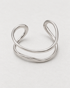 PARLX Double Loop Cuff in polished steel on light concrete — supplier-referenced rendering