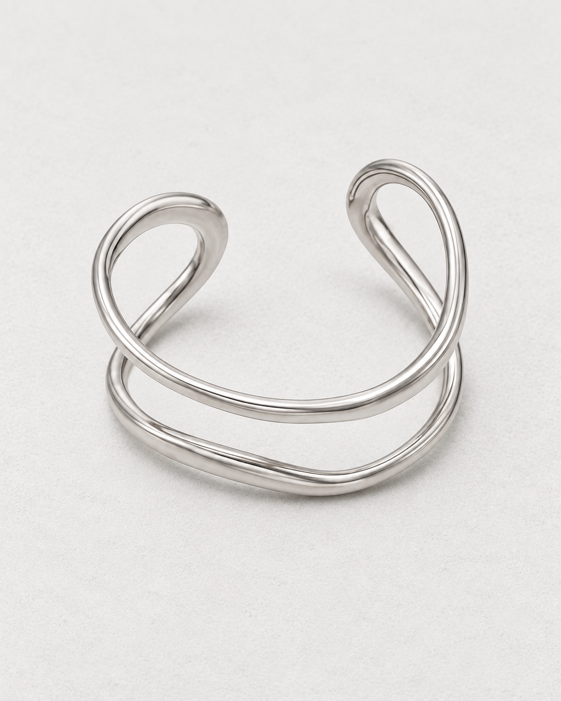 PARLX Double Loop Cuff in polished steel on light concrete — supplier-referenced rendering