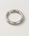 Offset Ring — Polished steel — rounded open band on pale concrete