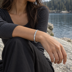 PARLX Pavé Cuff in steel, worn by a woman beside a lake — generated lifestyle image