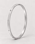 PARLX Solitaire Cuff — polished steel on light concrete, supplier-referenced rendering